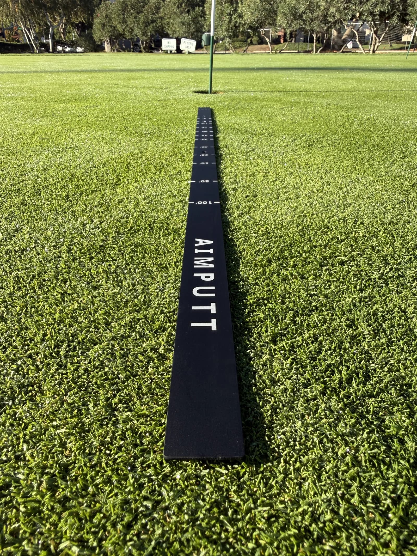 AimPutt distance-control rail set up on a putting green